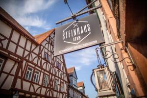 a sign for a restaurant on a building at STEINHAUS 1718 in Büdingen +6 photos