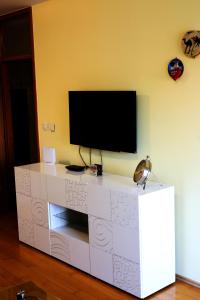 a white entertainment center with a flat screen tv on a wall at Apartman Klara in Karlovac