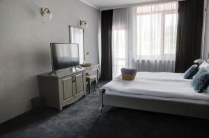 Кровать или кровати в номере Prity Sport Botique Hotel