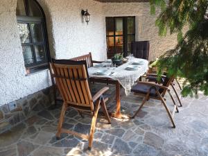 a wooden table and chairs on a patio at APARTMA ARNIKA Rogla, Turistično naselje NUNE RESNIK, RESNIK 110 in Zreče