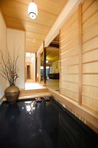 a swimming pool in a house with a vase at Yamagata Kyomachi Hatago Gojo Nishinotoin in Kyoto