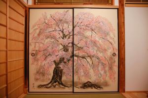 a painting of a tree on a wall at Yamagata Kyomachi Hatago Gojo Nishinotoin in Kyoto
