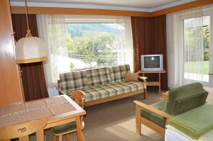 a living room with a couch and a tv at Ferienhaus Antonia in Ehrwald