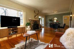 a living room with a large flat screen tv at Mi Casa - Healesville in Healesville