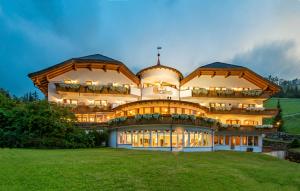 فندق كريستوف في فالداورا: مبنى كبير على تلة مع حقل أخضر