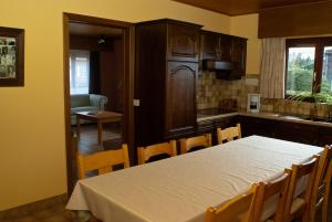 a kitchen with a table and chairs and a table and a table and a kitchen at 't Bruggeske in Mol