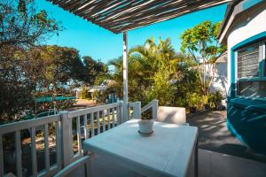 a white table on the balcony of a house at Surf Motel in Umdloti