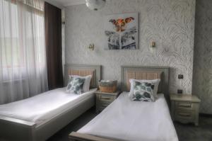 Postel nebo postele na pokoji v ubytování Prity Sport Botique Hotel