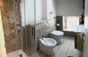 a bathroom with a toilet and a glass shower at B&B LOFT EDEL BEACH in Civitanova Marche +18 photos