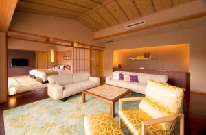 a living room with a couch and a bed at ABBA Resorts Izu - Zagyosoh in Ito +130 photos