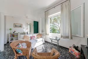 a living room with a white couch and a window at JOIVY Sea View Flat with Balcony, Cinque Terre in Monterosso al Mare