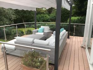 a patio with a couch on a deck at nikos house; in Stockholm