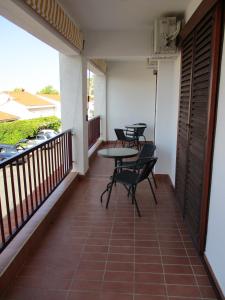 a balcony with tables and chairs on it at Apartments Meni in Drage