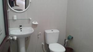 a small bathroom with a toilet and a sink at K Holiday in Tissamaharama