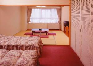 Postel nebo postele na pokoji v ubytování Hotel Chalet Yuzawa Ginsui