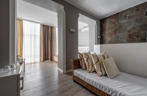 a living room with a couch with pillows on it at Pallada Hotel in Ternopilʼ