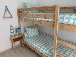a bedroom with two bunk beds and a table at PureLight Marbella in Marbella