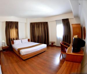Posteľ alebo postele v izbe v ubytovaní Kawan Hotel