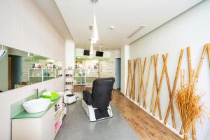 a bathroom with a chair in a room with skis on the wall at Rhodos Horizon Blu-Adults Only in Rhodes Town