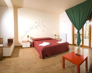 a bedroom with a red bed and a red table at Leccesalento Bed And Breakfast in Lecce