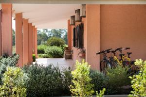 two bikes parked on the side of a building at Hotel Su Giudeu in Chia