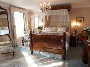 a bedroom with a large bed with a canopy at Queen Anne House in Portland
