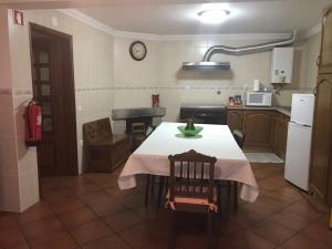 a kitchen with a table with a white table cloth at Casas da Estrela in Gouveia