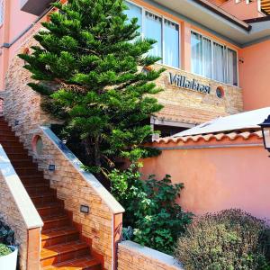 a pine tree sitting on the side of a building at Villa Erasi in Fiumicino