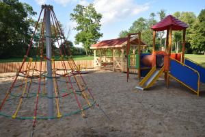 a playground with a slide and a swing set at Pensjonat Sztynort in Sztynort