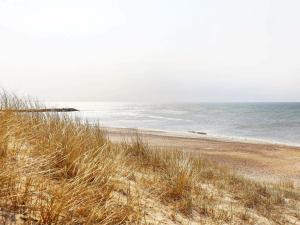 a sandy beach with a view of the ocean at 6 person holiday home in Lemvig in Lemvig