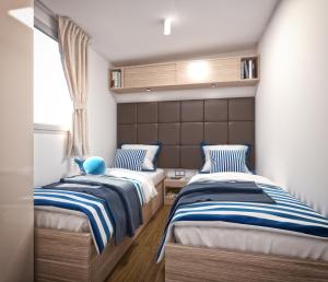 Posteľ alebo postele v izbe v ubytovaní Victoria Mobilehome in Istra Premium Camping Resort + 25 fotografií
