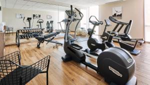 a gym with several treadmills and exercise bikes at Château Saint-Jean, Relais & Châteaux in Montluçon