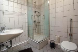 a bathroom with a shower and a toilet and a sink at #centralstation #130qm Hauptbahnhof #netflix in Karlsruhe +14 photos
