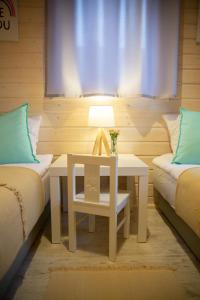 a room with two beds and a table and a window at Sielankownia in Radków +29 photos