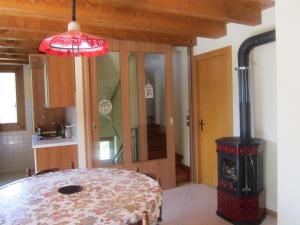 a kitchen with a wood stove in a room at Casa di Bagattini in Posina