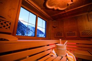 a bench in a room with a window at Chasa Castello relax & spa in Samnaun