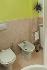 a bathroom with a toilet and a sink at Antico Granaione in Rapolano Terme