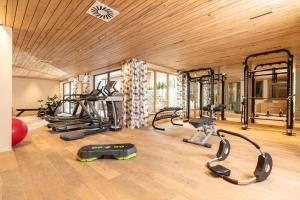 a gym with several exercise equipment in a room at Alpbacherhof Mountain & Spa Resort in Alpbach