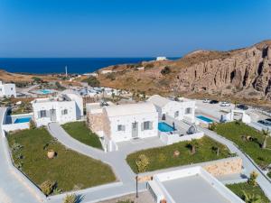an aerial view of a white villa with the ocean at Desiterra Resort in Fira