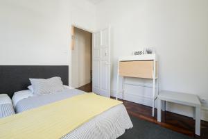 a small bedroom with two beds and a desk at Baixa24 · City Center Private Sun Deck Apartment in Porto