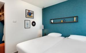 Postel nebo postele na pokoji v ubytování Hôtel ibis Styles Clermont-Ferrand Gare
