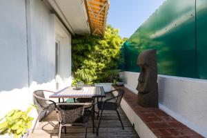 a patio with a table and chairs on a balcony at 6 bedrooms seaview house, Old Town in Nice