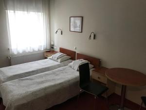 Postel nebo postele na pokoji v ubytování Hommiku Guesthouse