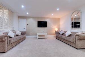 a living room with two couches and a flat screen tv at RST Rodney Street in Liverpool