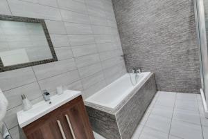 a bathroom with a bath tub and a sink at RST Rodney Street in Liverpool