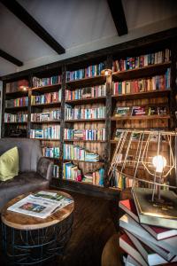 a room with a library filled with books at Spreewelten Hotel in Lübbenau