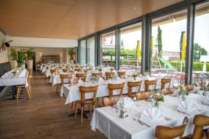 a row of tables and chairs in a restaurant at Hotel Schützenhaus in Uznach