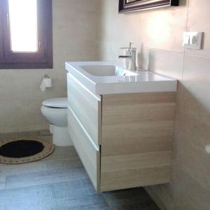 a bathroom with a sink and a toilet at Casalacapillajelgueres in Cangas de Onís +40 photos