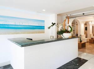 a counter in a room with a painting of the ocean at Hotel Playas de Paguera in Paguera