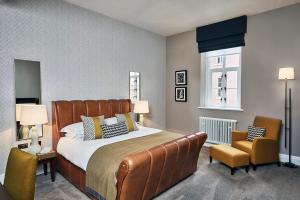 a bedroom with a large bed and two chairs at Hotel du Vin Birmingham in Birmingham +59 photos